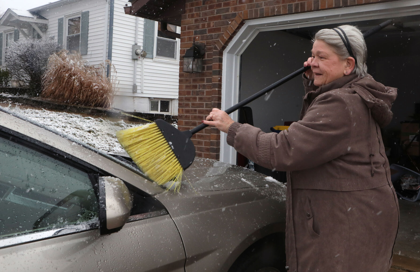 Brenda Snyder sweeps snow